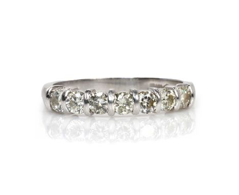 A platinum and diamond seven stone ring,  with a row of seven round brilliant cut diamonds, with a combined weight of approxi