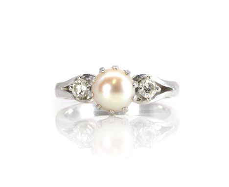 A pearl and diamond three stone ring,  with a central cultured pearl, untested, 6.70mm, flanked by two round brilliant cut di