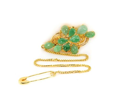 A jade cluster brooch,  with ten pear shaped jade cabochons, claw set, to pin and hook fitting, with a safety chain, measurin