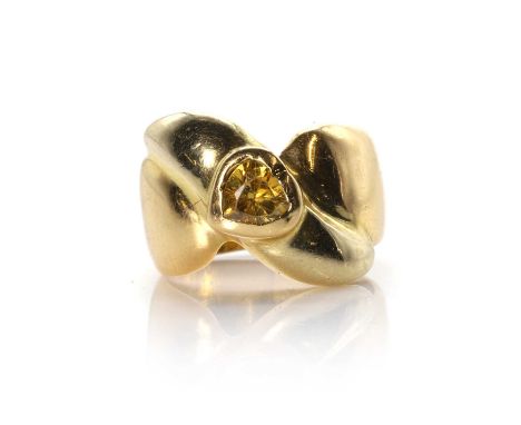 A heart shaped cubic zirconia ring,  the heart shaped yellow cubic zirconia, bezel set to a crossover tapered band, unmarked 