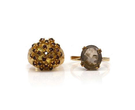 A garnet cluster ring and a 9ct gold smoky quartz ring, a garnet bombé cluster ring,one stone deficient, tested as approximat