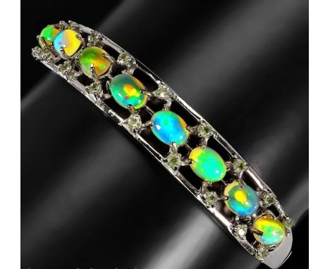 A 925 silver bangle set with cabochon cut opals, L. 6cm.