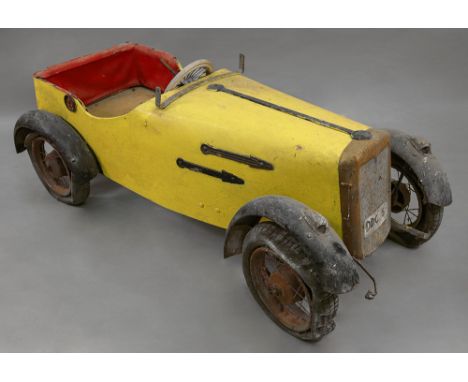 A child's vintage wooden and metal pedal sports car, DDC 5 with yellow body work, approximately 133cm long x 60cm wide x 51cm