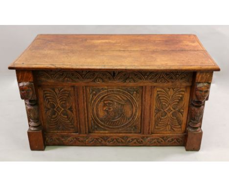 A reproduction foliate carved oak coffer, in 17th century style, of panelled construction, with a central portrait roundel an