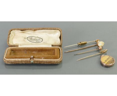A collection of various 9ct gold tie pins: Including opal stone, 9ct gold locket etc. (5)