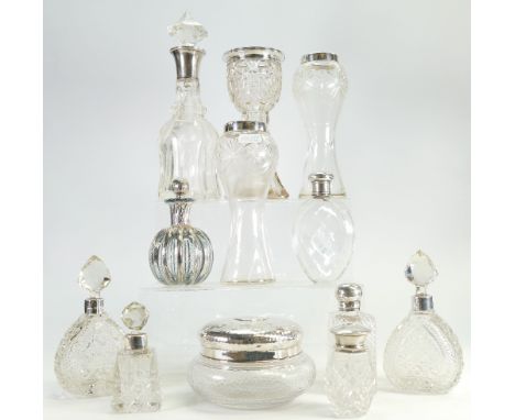 A collection of silver topped glass ware item to include: Silver topped scent bottles, vases, hip flask etc. (12)