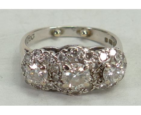 18ct white gold diamond ring: The three larger diamonds surrounded by diamond chips, three stones approx 1ct, size J, 5.5 gra