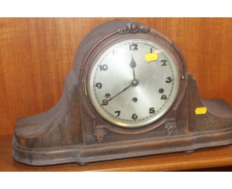AN OAK MANTEL CLOCK