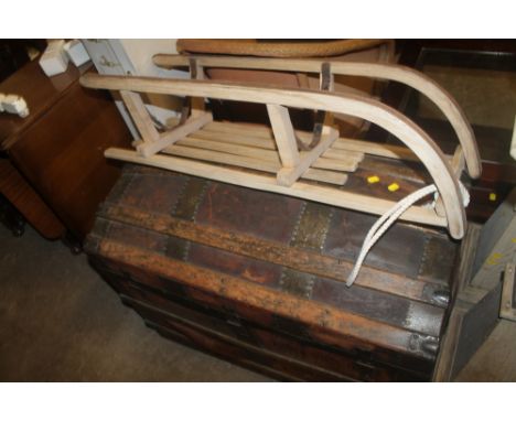 A VINTAGE TRUNK TOGETHER WITH A SLED