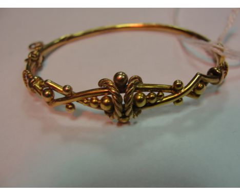 A Victorian gold bangle CONDITION REPORT: Tests as 9ct hallmarked to clip but only GT legible. Minor dents to back section of