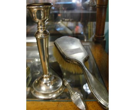 A HM silver shoe horn; together with a candlestick and brush