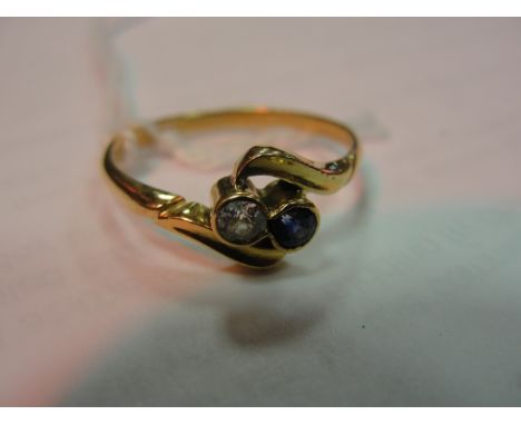 An 18ct diamond and sapphire crossover ring