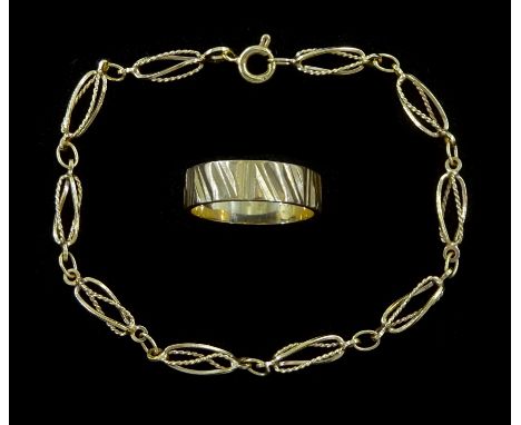 Gold fancy openwork twist link bracelet and a gold wedding band, both hallmarked 9ctCondition Report:Approx 6.45gm, bracelet 