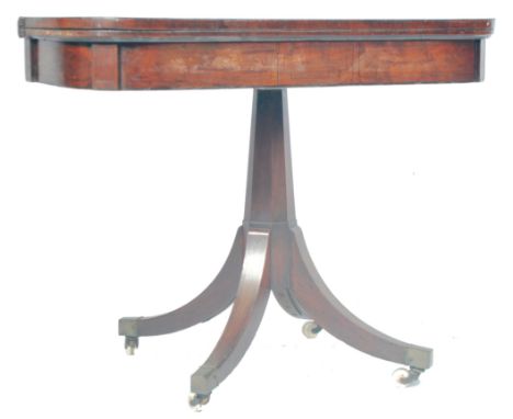 An antique 19th Century Georgian Regency Period mahogany games / card table having a fold over top with rounded corners swive