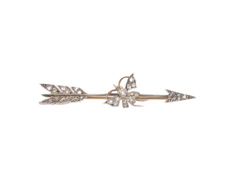 VICTORIAN DIAMOND SET ARROW AND BUTTERFLY BROOCH. The fletching, arrow head and butterfly motif are highlighted with a total 