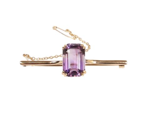 9CT GOLD AMETHYST BROOCH. One step cut amethyst approx. 13.10ct, measuring approx. 18 x 12mm. Double four claw bar brooch mou