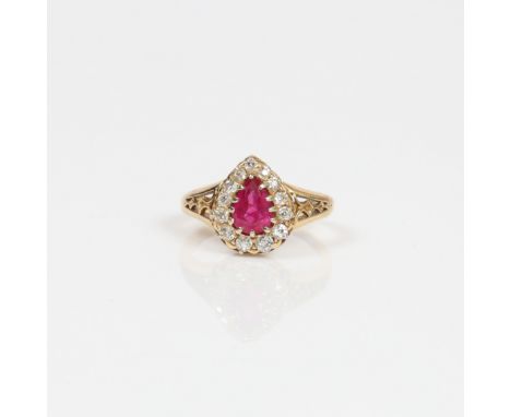 A LATE VICTORIAN RUBY AND DIAMOND RING. One faceted pear shaped ruby approx. 1.10ct. Ruby measures approx. 8 x 5.5mm. Surroun