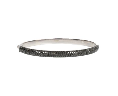 THEO FENNELL BLACK DIAMOND BANGLE. The top of the bangle set with five rows of pavé set black diamonds. A hinged D-profile ba