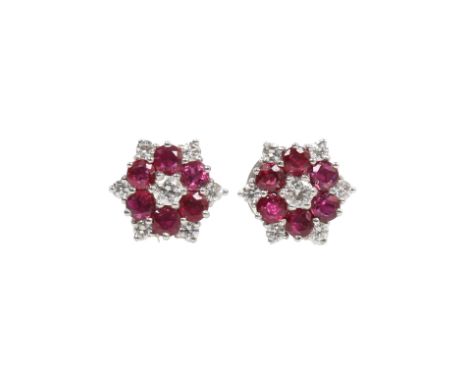 A PAIR OF RUBY AND DIAMOND CLUSTER STUD EARRINGS. Each earrings consists of six round faceted rubies each measuring approx. 3