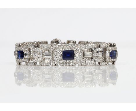 AN ART DECO SAPPHIRE AND DIAMOND BRACELET. An articulated link bracelet made up of geometric open work links. One principle r