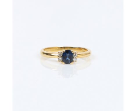 SAPPHIRE AND DIAMOND FIVE STONE RING. Set with oval mixed cut sapphire approx. 0.44ct, measuring 5 x 4mm. Flanked with two ro