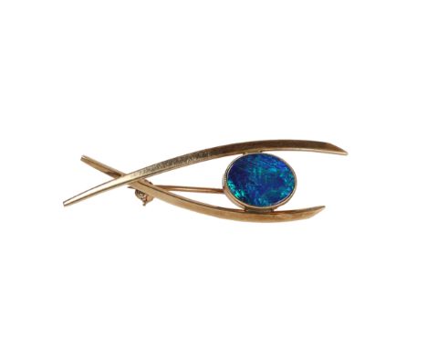 VINTAGE BLACK OPAL TRIPLET BROOCH. One oval black opal triplet measures 12 x 9mm. A milgrain bezel, closed back setting. Broo