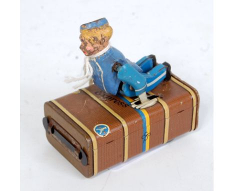 A Gesher German tinplate clockwork figure of a bellboy with case comprising blue dressed bellboy with hat and brown detailed 