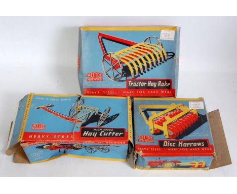 A collection of various boxed and loose Mettoy tinplate and clockwork tractors and agricultural equipment to include a boxed 