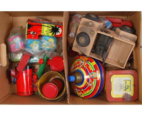 A collection of mixed tinplate, plastic and wooden toys and accessories to include a Peter Pan registered automatic chocolate