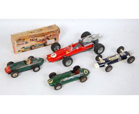 Four boxed and loose tinplate, friction drive and clockwork racing cars to include a Schuco No. 1073 Ferrari 320PS F2 racing 