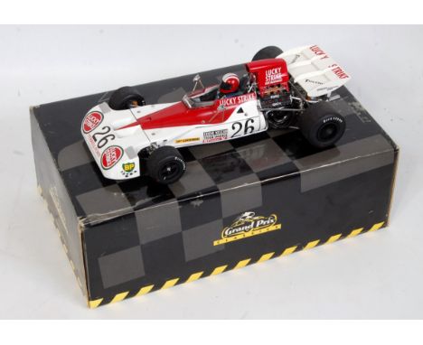 An Exoto 1/18 scale model of a Tyrrell Ford 003 Lucky Strike Eddie Keizan F1 racing car, finished in red and white with drive