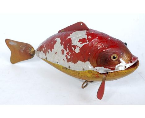 An unusual wooden and sheet metal model of an articulated swimming fish fitted with single fixed key clockwork mechanism, ove
