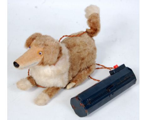 A Japanese tinplate and battery operated model of a standing and rising dog, covered in two-tone mohair with 'bark' action an