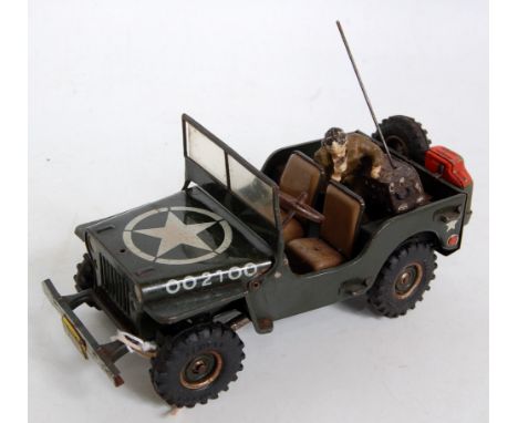 An Arnold Toys No. JS2100 US Army Jeep of tinplate construction, fitted with friction drive mechanism, comprising green body 