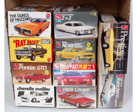 An AMT/ERTL 1/25 scale classic car and racing plastic kit group, all appear as issued, to include a Street Freaks Chevy 2 Rat