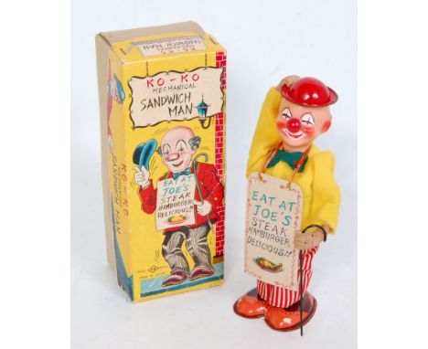 A TN Toys of Japan tinplate and mechanical Ko-Ko Sandwich Man, comprising of a fully clothed tinplate man with detailed tinpr