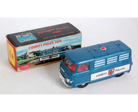 A Guiterman Maks plastic and battery operated model of a Commer County Police van comprising of blue body with red interior a