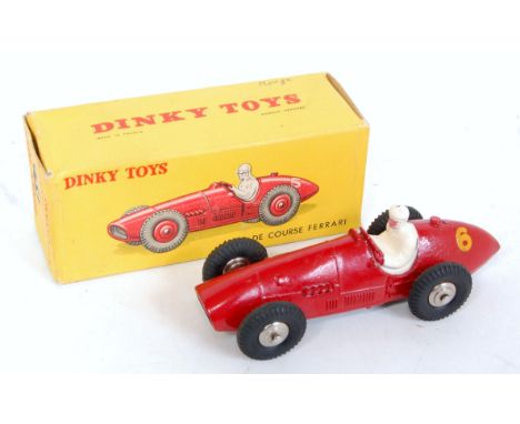 A French Dinky Toys No. 23J Ferrari F1 racing car comprising of red body with spun hubs and racing No. 6, white driver, in th