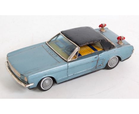 A Bandai of Japan tinplate and battery operated model of a Ford Mustang, comprising of metallic blue body with black roof and