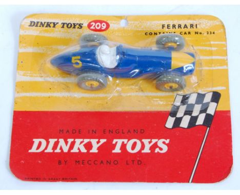 A Dinky Toys No. 209 Ferrari racing car comprising of blue body with yellow triangular nose cone and yellow plastic hubs, com