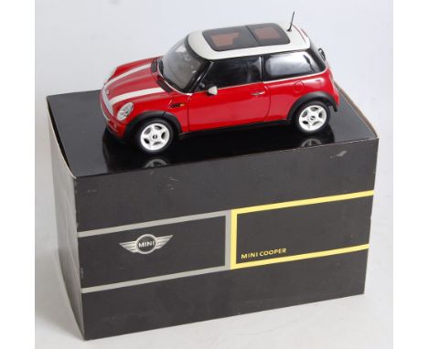 A Kyosho 1/18 scale model of a Mini Cooper finished in red and white, model No. 80430139276 housed in the original Mini Coope