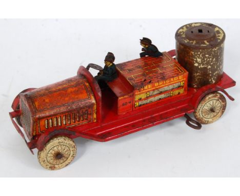 An early 20th century tinplate and clockwork model of a Wells Fire Engine, missing some components and body is heavily rusted