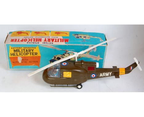 A TN Toys of Japan vintage plastic and battery operated model of a military helicopter with automatic action, comprising of m