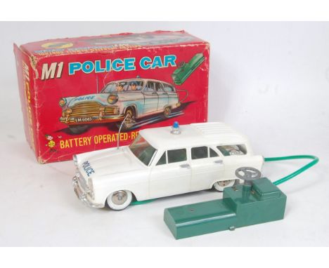 A Marx Toys of Hong Kong plastic and battery operated remote control M1 police car, comprising white body with blue flashing 