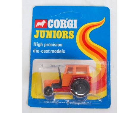 A Corgi Juniors No. 4 Zetor tractor, comprising orange and red body with black plastic wheels housed on the original backing 