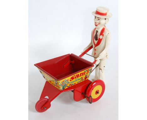 A Marx Toys Sam The Gardener, tinplate and plastic model comprising of red and yellow wheelbarrow with detailed tinprinted an