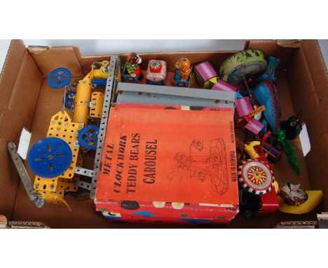 A collection of various boxed and loose Meccano, tinplate and plastic clockwork toys to include a Romanian metal clockwork te