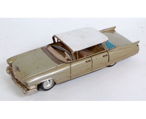 A Bandai of Japan tinplate and friction drive model of a Cadillac comprising of metallic grey body with white roof, loose exa