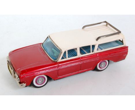 A Bandai tinplate and friction drive model of a Nash Rambler station wagon comprising metallic red body with white roof and d