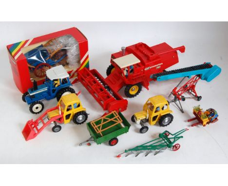 A collection of various loose and boxed Britains farm implements and accessories to include a Massey Ferguson 760 combine, a 